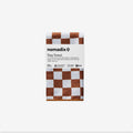 Nomadix Tiny Towel in brown and white checkered pattern, made with certified recycled materials, folded front view.