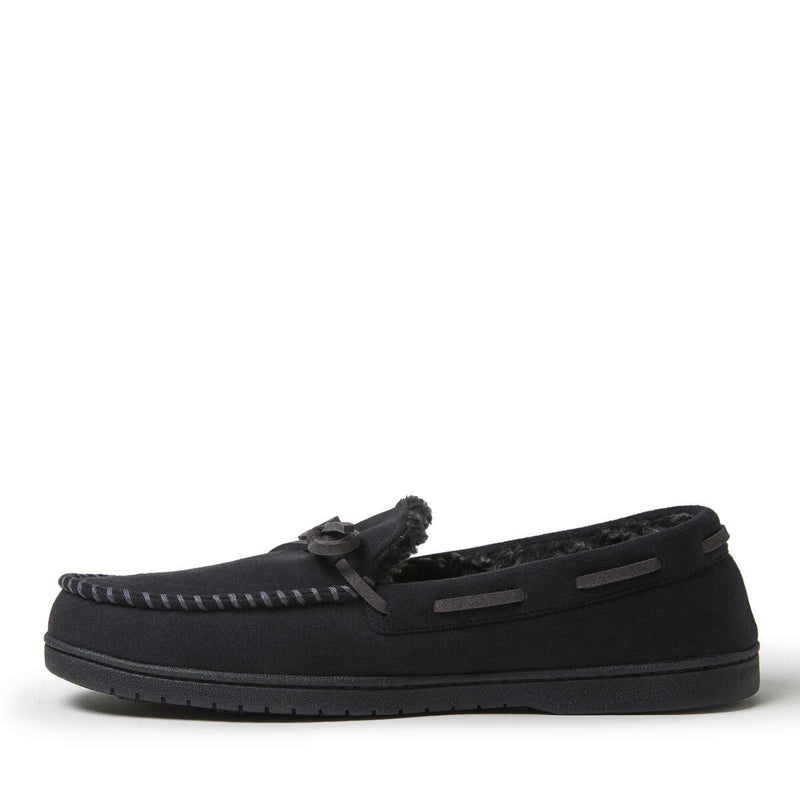 Dearfoams Toby Microsuede Tie Moccasin slippers in black with faux fur lining, decorative stitching, and rubber outsole, side view.