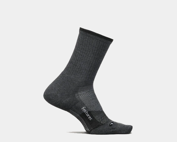 Feetures Trail Max Cushion Mini Crew Sock in dark gray with ribbed cuff, arch support, and cushioned footbed, side view