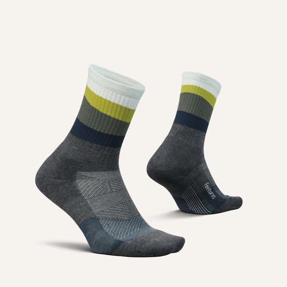 Feetures Trail Max Cushion Mini Crew Sock in gray with ribbed multicolor stripes of white, olive green, navy, and light gray.