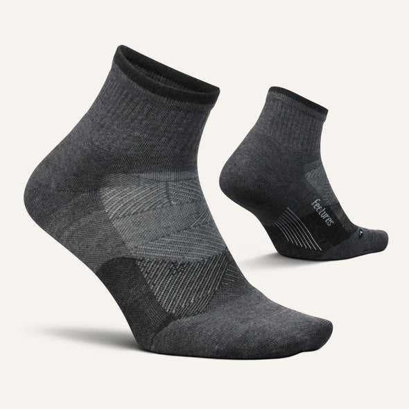 Feetures Trail Max Cushion Quarter Sock in dark gray with targeted compression and breathable mesh panels, side view.