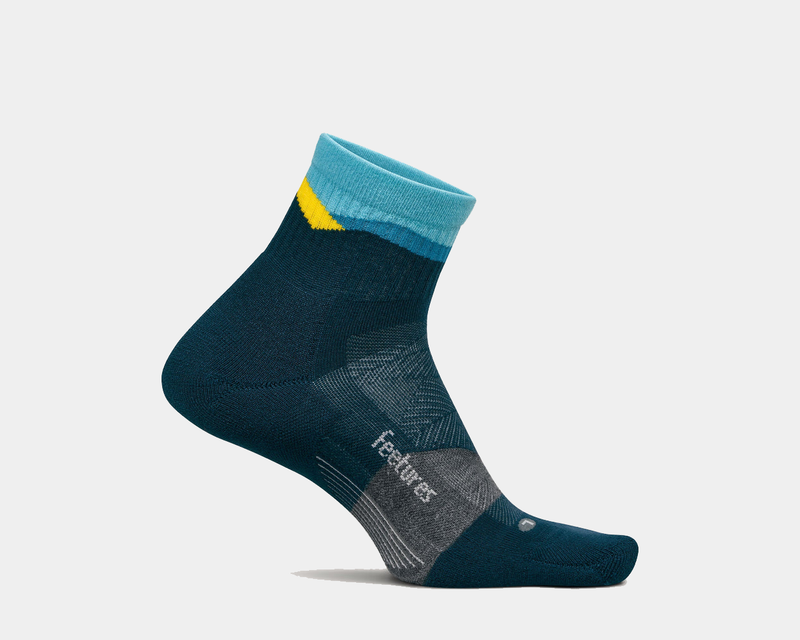 Feetures Trail Max Cushion Quarter Sock in navy blue with light blue cuff, yellow accent, and gray arch support, side view