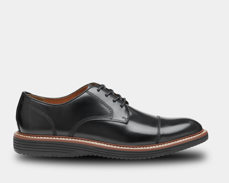 Johnston & Murphy Upton Cap Toe dress shoes in black leather with cap toe design, contrast stitching, and cushioned sole, side view.