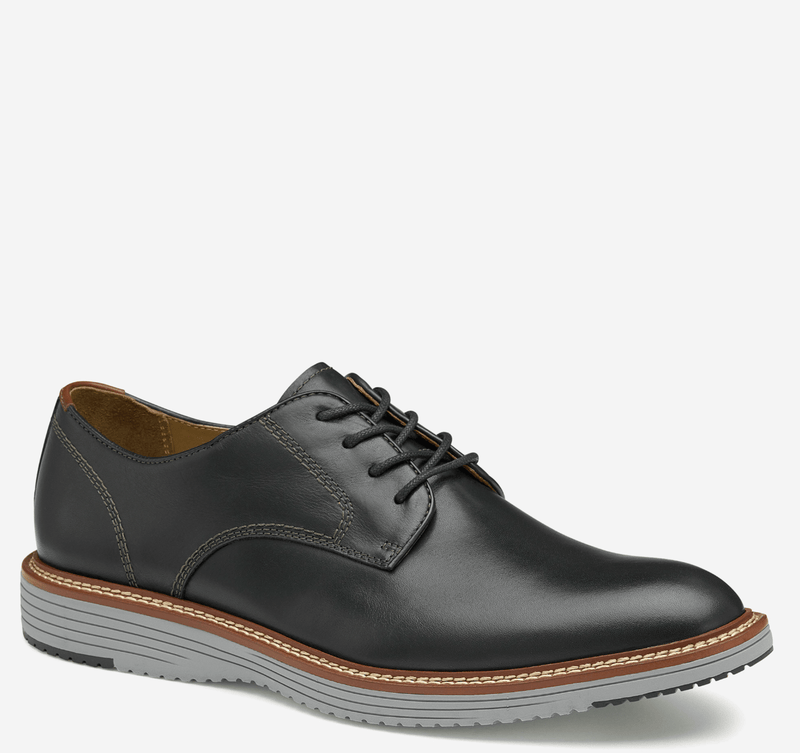 Johnston & Murphy Upton Plain Toe shoes in black leather with contrast stitching, lace-up closure, and gray rubber sole, side view.