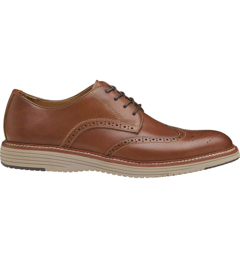 Johnston & Murphy Upton Wingtip shoes in brown leather with brogue detailing and beige rubber sole, side view.
