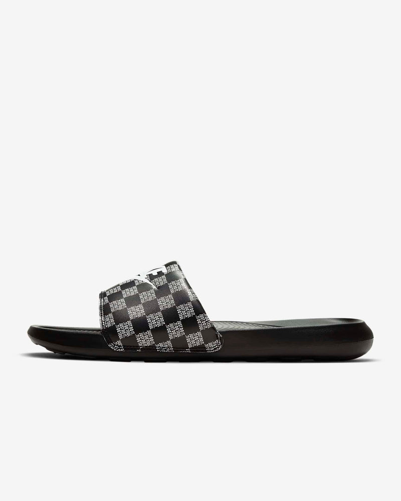 Nike Victori One Printed slides with black and white checkered strap and cushioned black sole, side view.