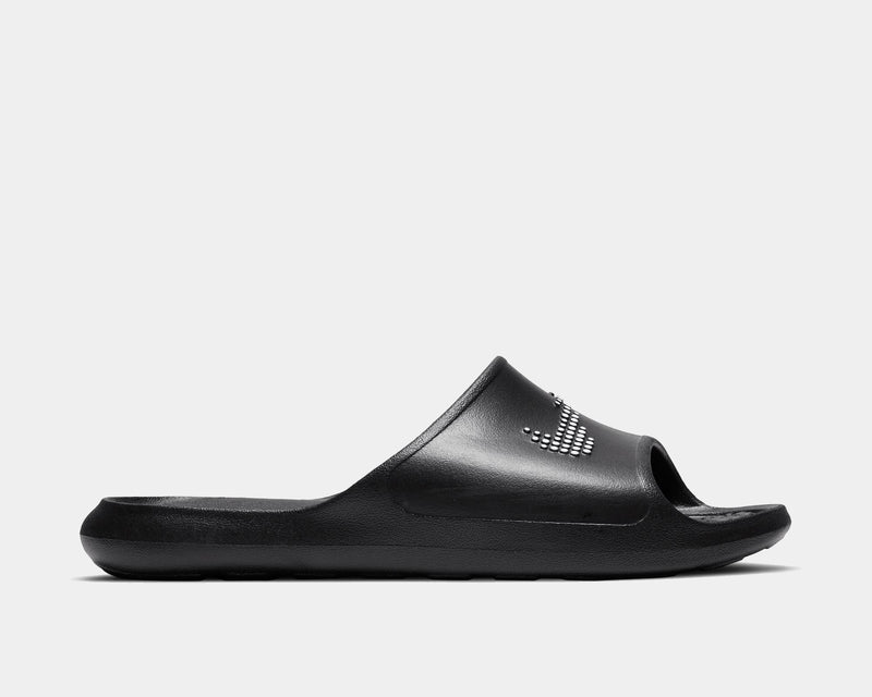 Nike Victori One Shower sandals in black featuring a textured slide design, perforated details for drainage, and cushioned footbed, side view.