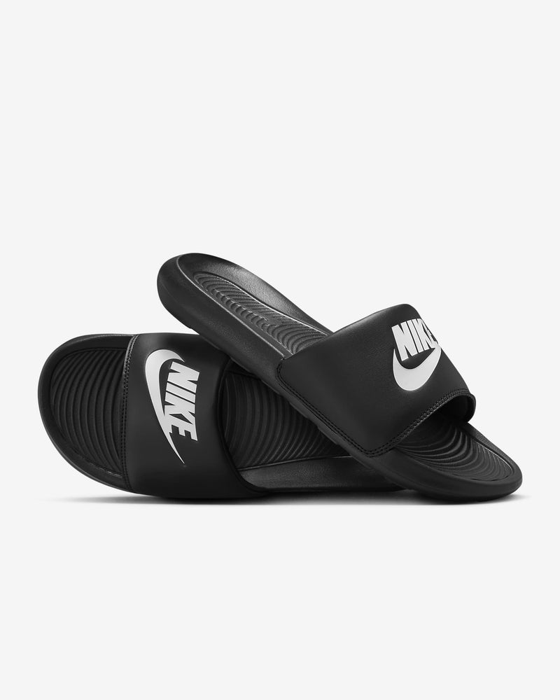 Black slide sandal with a brand logo on a light gray background