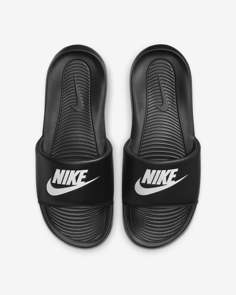 Black slide sandal with a brand logo on a light gray background