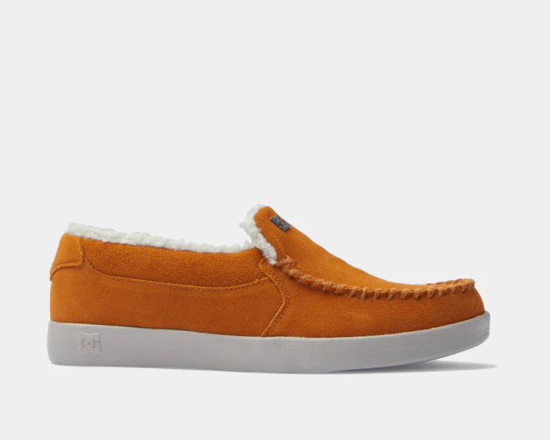 DC Footwear Villain 2 SE slip-on shoes in orange suede with white faux fur lining and stitched details, side view.