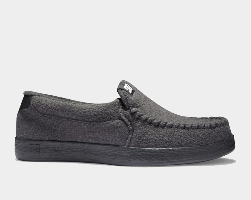 DC Footwear Villain 2 slip-on shoes in dark gray textile with moc toe stitching and black rubber sole, side view