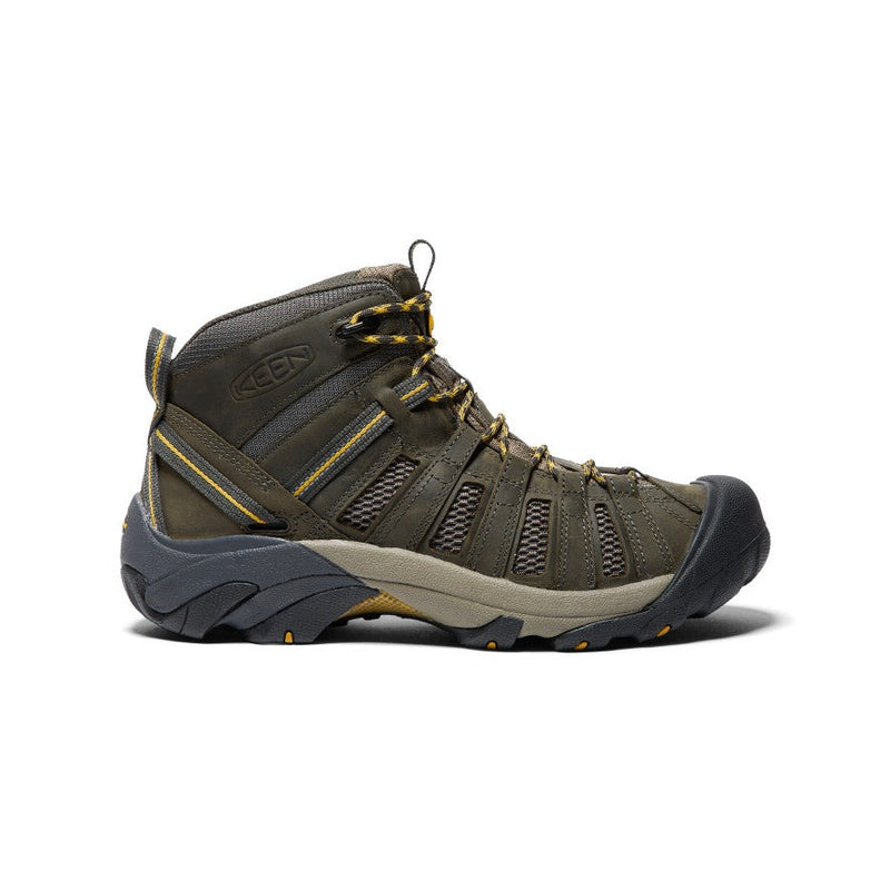 Keen Voyageur Mid hiking boots in brown with breathable mesh panels, durable leather construction, and rugged outsole, side view.