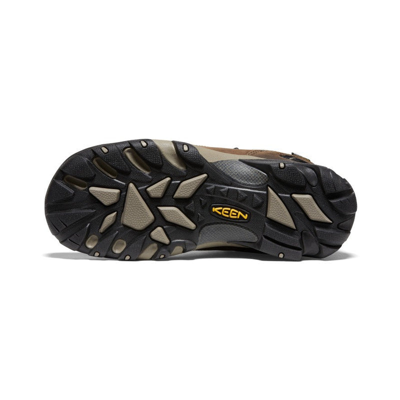 Keen Voyageur hiking shoes outsole with multi-directional lugs and durable rubber in black and tan, bottom view.