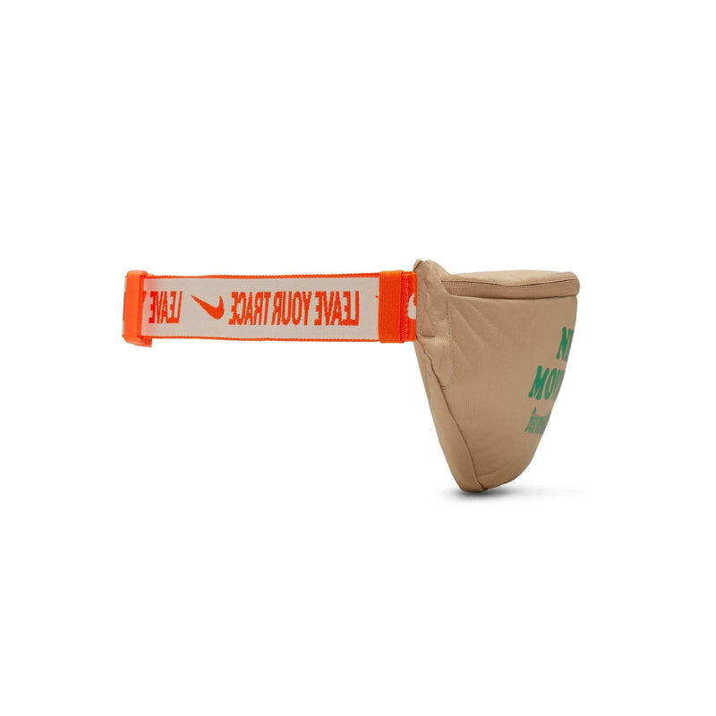 Nike Waist Pack in beige with green text on the front and an orange adjustable strap featuring "Leave Your Track" printed. Side view.