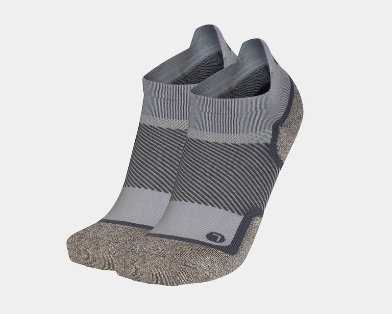 OS1st Wellness Performance No Show Socks in gray and tan with arch support and moisture-wicking fabric, front angled view.