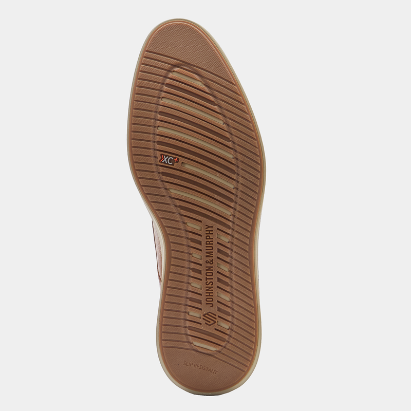 Johnston & Murphy XC+ Parker shoe outsole in tan showing slip-resistant rubber with branded grooves, bottom view.