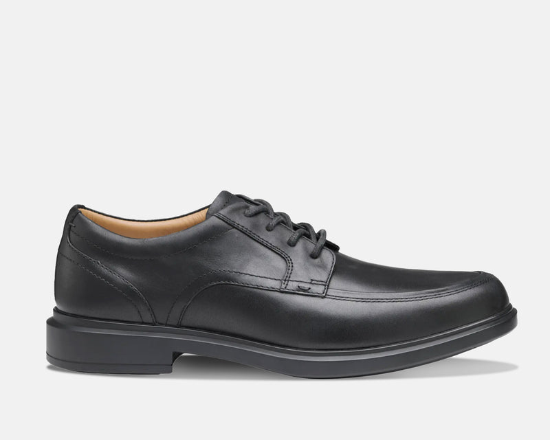Johnston & Murphy XC4 Stanton 2.0 Waterproof Moc Toe shoes in black leather with moccasin-style stitching and lace-up design, side view.
