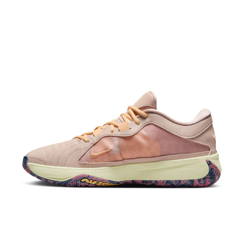 Nike Zoom Freak 5 basketball shoes in peach with textured mesh upper, embroidered Swoosh, and multicolor patterned outsole, side view.